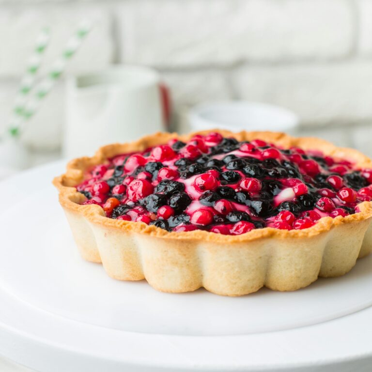 A visually appealing mixed berry tart with a golden crust, perfect for dessert lovers.