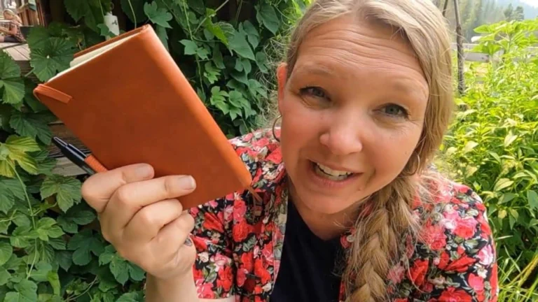 Debt-free homestead lifestyle woman with notebook and garden