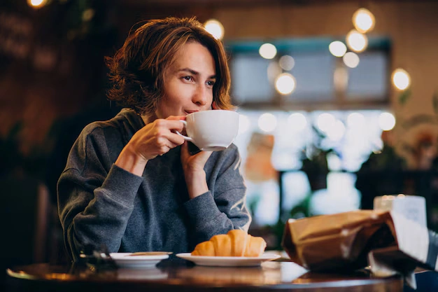 A woman peacefully sipping coffee while food icons